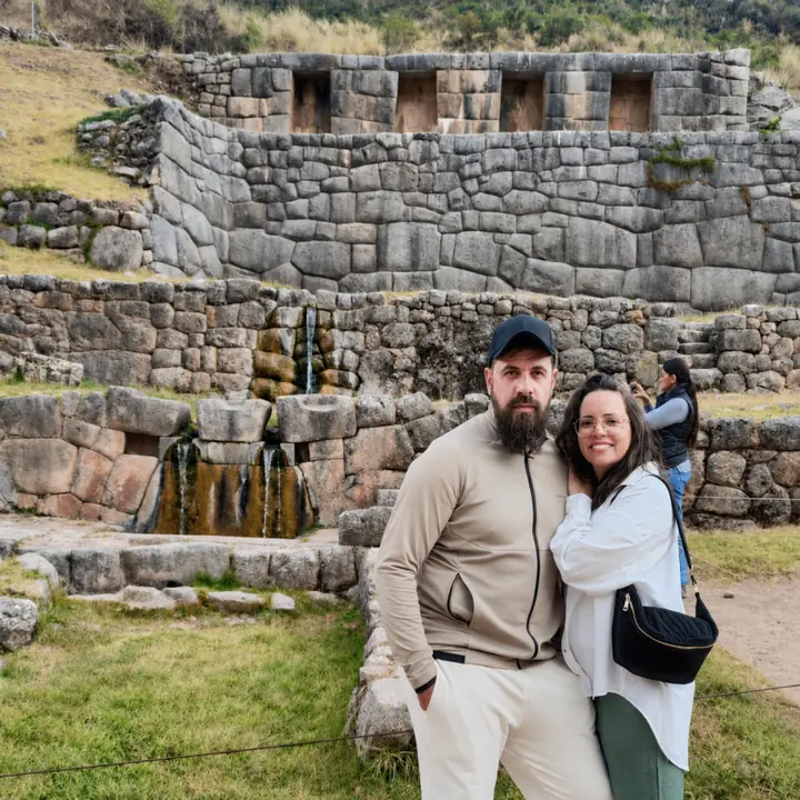 Couple posing before the Inca water fountains at Tambomachay near Cusco.