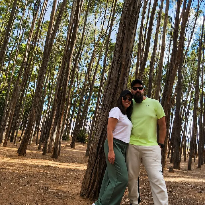 Couple standing beside a eucalyptus tree in the countryside near Cusco.