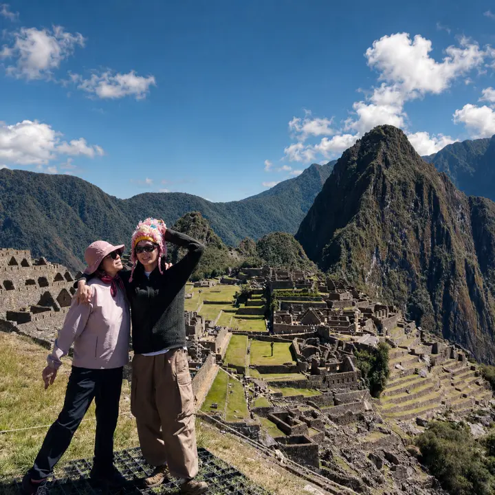 Two travelers sharing a moment above the Machu Picchu citadel