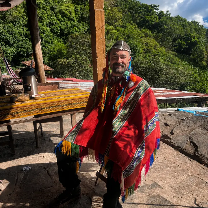 Traveler wearing a colorful Andean poncho during the Inca Jungle tour.