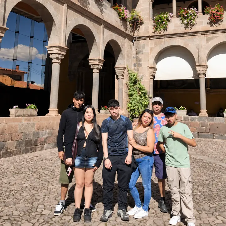 Travel group visiting the historic Qorikancha complex in central Cusco.