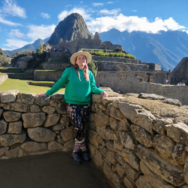 Smiling traveler beside the ancient stone terraces of Machu Picchu