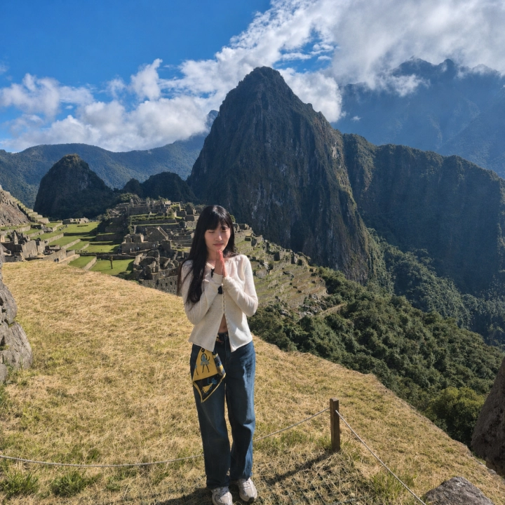 Traveler enjoying a peaceful moment before Machu Picchu in Peru