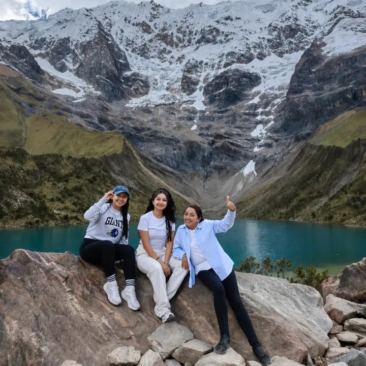 Travel group celebrating beside Humantay Lake in the Peruvian Andes.