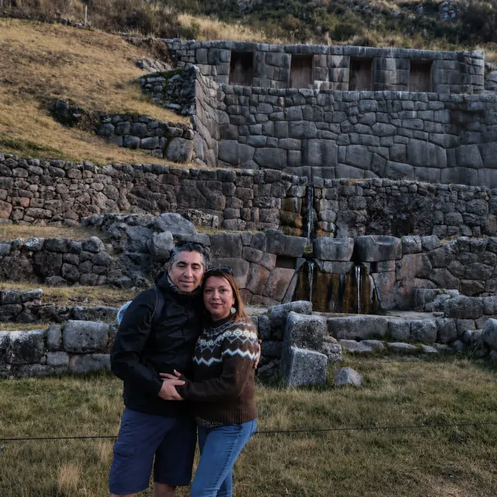 Couple visiting the stone terraces and water channels of Tambomachay.